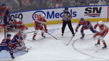 a hockey game is being played in front of a banner that says ess medals