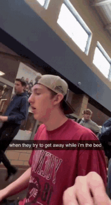 a man wearing a red shirt that says ' cowboy ' on it