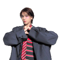a woman in a suit and tie is making a peace sign