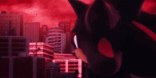 shadow the hedgehog is standing in front of a city with a red sky in the background .