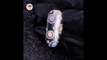 a close up of a nail with circles painted on it