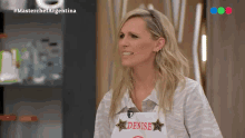 a woman is wearing an apron that says denise
