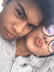 a boy and a girl are posing for a picture