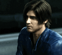a man wearing a blue leather jacket with a zipper on the front