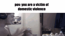 a man wearing headphones with the words pov : you are a victim of domestic violence above him