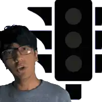 a man wearing glasses is standing in front of a black traffic light