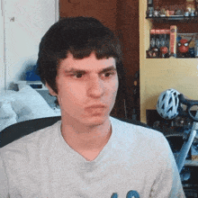 a man wearing a white shirt with a blue letter o on it