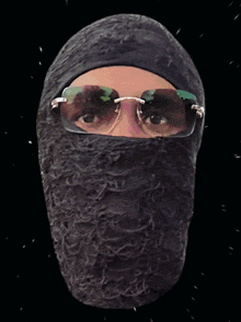 a statue of a person wearing sunglasses and a black mask