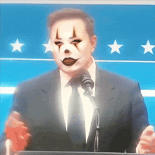 a man in a suit and tie has a clown face painted on his face while speaking into a microphone
