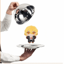 a person is holding a silver tray with a stuffed animal on it