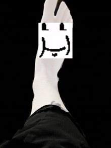 a foot with a face drawn on it
