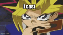 yugi from yu gi oh is holding a card in his hand .