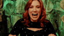 a woman with red hair is screaming in front of a green background