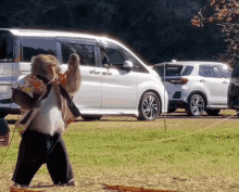 a monkey is standing in front of a white suv