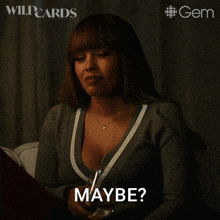 a woman in a gray sweater says maybe