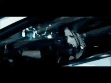 a white mercedes is driving through a tunnel