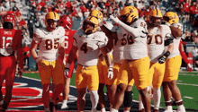 a group of football players are huddled together with one wearing the number 4
