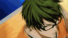 a man with green hair and glasses looks down at something