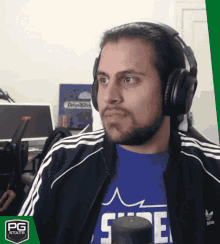 a man wearing headphones and a blue shirt with the letter e on it
