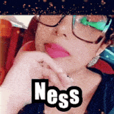 a woman wearing glasses with the word ness written on her face
