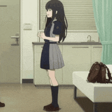a girl in a school uniform is standing in a room holding a cup of coffee