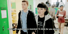 a man and a woman are walking in a hallway and the woman says that 's why women were invented .