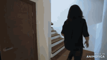 a woman in a black shirt is walking down stairs made in animatica
