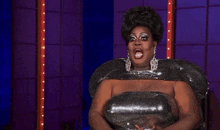 a drag queen says " crickets bitch " while wearing a sequined dress