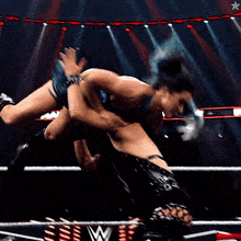 a blurry picture of a wrestling match with a star on the bottom right