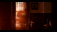 a blurry picture of a window with the sun shining through