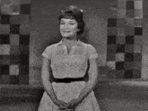 a black and white photo of a woman in a striped shirt