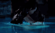 a couple is hugging in a swimming pool at night