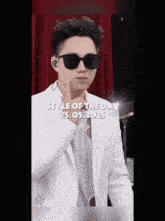 a man wearing sunglasses and a white suit says style of the day on the bottom