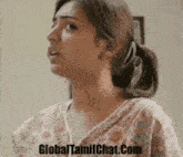 a close up of a woman 's face with the website globaltamilchat.com in the corner .