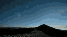 a starry night sky over a mountain range