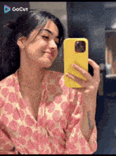 a woman is taking a picture of herself in a mirror
