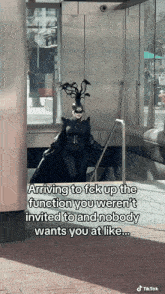 a woman in a black costume is walking down stairs with a caption that says arriving to fck up the function