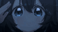 a girl with black hair and blue eyes is crying