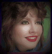 a close up of a woman 's face with green eyes and red lipstick