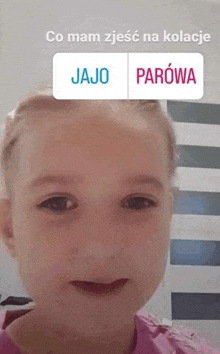 a little girl with a sticker on her face that says jajo