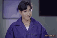 a man wearing a blue jacket and a necklace has the name judleklek702 on the bottom