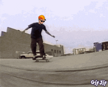a man wearing a hard hat and sunglasses is riding a skateboard on a gif