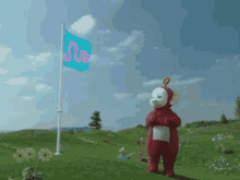 a teletubbies character is standing in front of a flag
