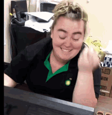 a woman wearing a black shirt with a bp logo on it