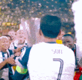 a man wearing a white shirt with the number 7 on the back