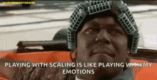 a man wearing a helmet is sitting in a car with the words `` playing with scaling is like playing with my emotions ''