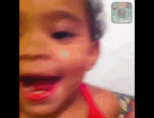 a close up of a child 's face with a picture of a camera on the bottom