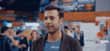a man in a blue shirt that says xroui