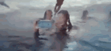 a group of people are taking a selfie in a hot tub .