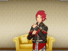 a man with red hair and a black jacket stands in front of a yellow couch